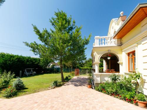 a house with a pathway leading to a yard at Apartment Elisabeta 02 by Interhome in Balatonőszöd