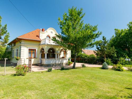 a small house in a yard with a grass field at Apartment Elisabeta 02 by Interhome in Balatonőszöd