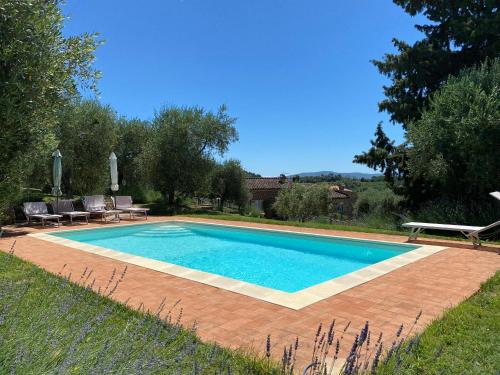 a swimming pool in the backyard of a house at Case Nell' Aia in Poggibonsi
