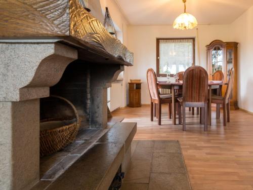 a living room with a fireplace and a dining room at Holiday Home Eifelnatur - Haus 1-4 by Interhome in Immerath