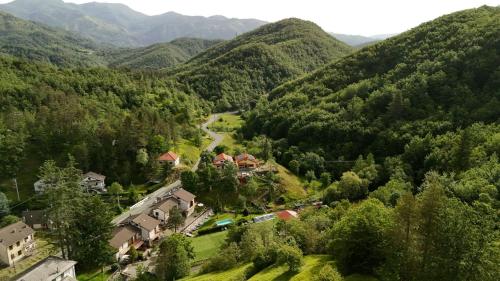 an aerial view of a house in a valley with mountains at Green Riviera Case Vacanza in Borzonasca