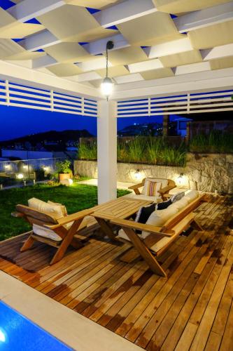 a deck with two lounge chairs and a pool at Villa Aleph-Kiralık Müstakil havuzlu lüx villa in Bodrum City