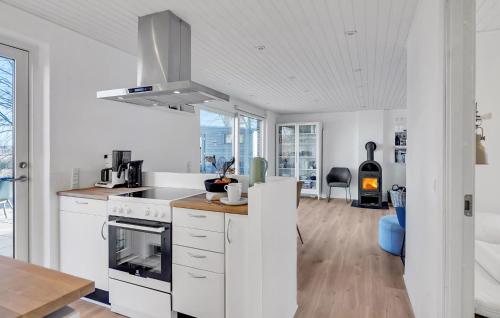 a kitchen with white cabinets and a stove top oven at Stunning Home In Hadsund With Wifi in Hadsund