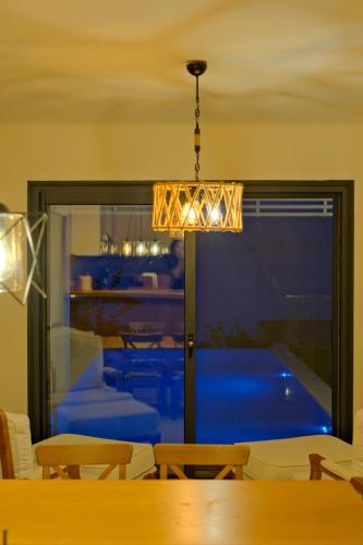 a dining room with a view of a pool at Villa Aleph-Kiralık Müstakil havuzlu lüx villa in Bodrum City