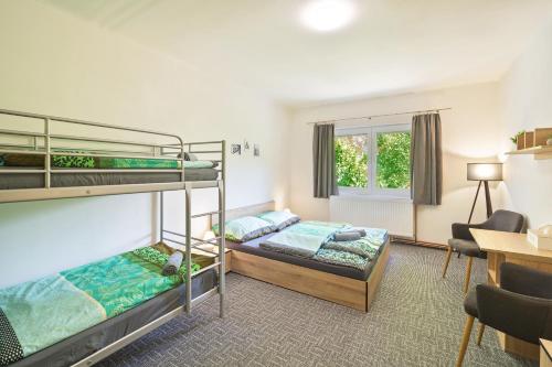 a bedroom with two bunk beds and a desk at U 2 soviček - Krkonoše in Jablonec nad Jizerou
