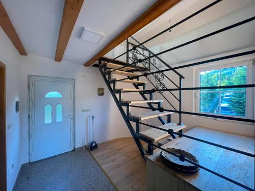 a spiral staircase in a room with a door at Zeleni kutak in Sarajevo