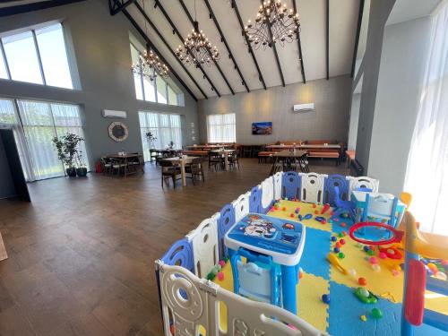 a large room with a table with a play equipment at Arena Apartments & Villas Guba in Quba