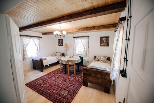 a living room with a table and a bed and a bedroom at Sielsko in Lipsko-Polesie
