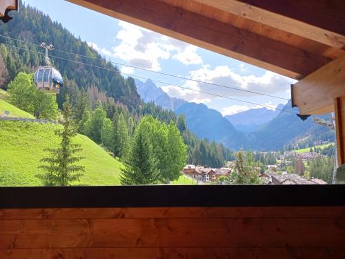 a view from a window of a mountain view at La Campagnola in Canazei