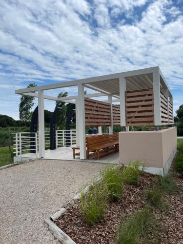 a gazebo with a bench in a field at Lino delle Fate Eco Resort in Bibione