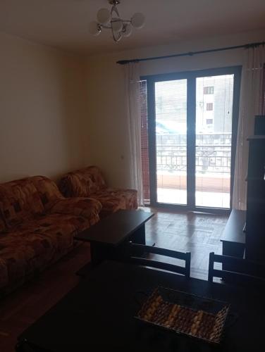 a living room with a couch and a table at Apartmani Ivan in Risan