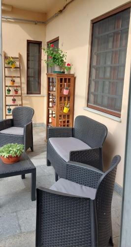 a group of chairs and tables on a patio at Oryza Guest House in Desana