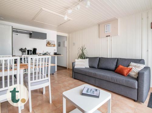 un salon avec un canapé et une table dans l'établissement Tranquiloue - Chez nous - 8min du PuyduFou, à La Verrie