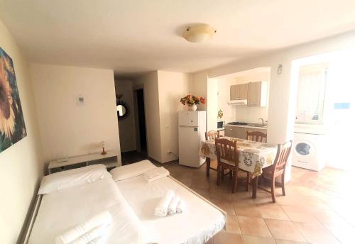 a living room with a table and a kitchen at Casa Vacanza Villa Aurora in Laureana Cilento