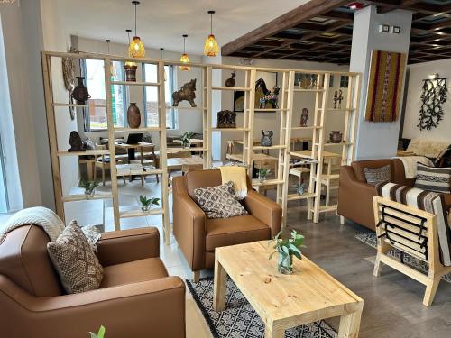 a living room with couches and a table and chairs at CASA CRISTOBAL Centenario in Cusco