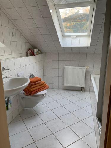 a bathroom with a sink and a toilet and a window at Appartement Kammblick in Gröbming