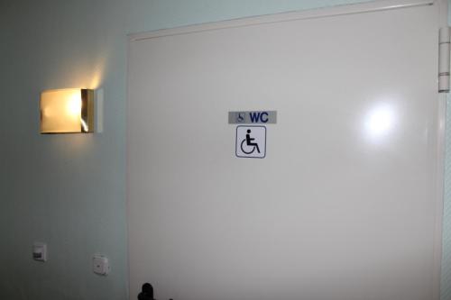 a white door with a sign on it in a room at Lauenburger Mühle in Lauenburg
