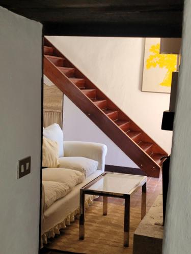 a living room with a couch and a table at Private 2 bedrooms home in Saturnia centre in Saturnia