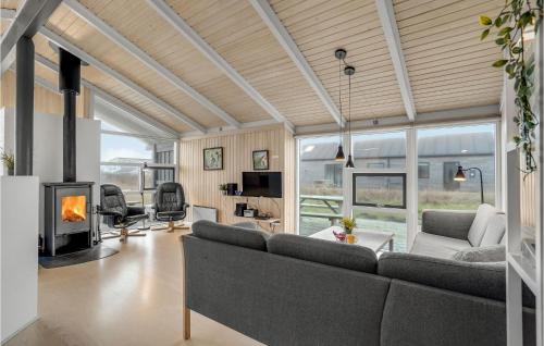 una sala de estar con un sofá y una chimenea en Cozy Home In Harboøre With Sauna, en Harboør