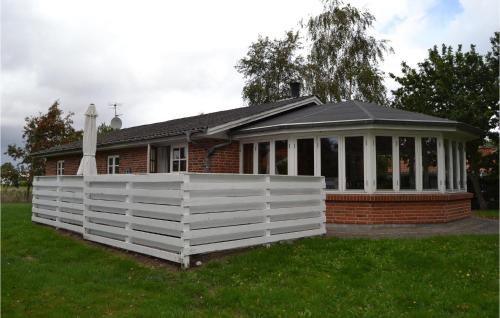 a house with a white fence in front of it at Holiday Home Juelsminde With Fireplace 7 in Juelsminde