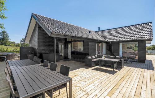 a wooden deck with a table and chairs on it at 4 Bedroom Nice Home In Odder in Odder