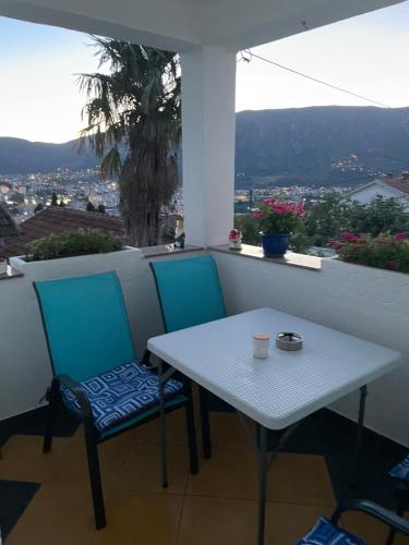 a table and two chairs on a balcony with a view at Villa Magnifica in Mostar