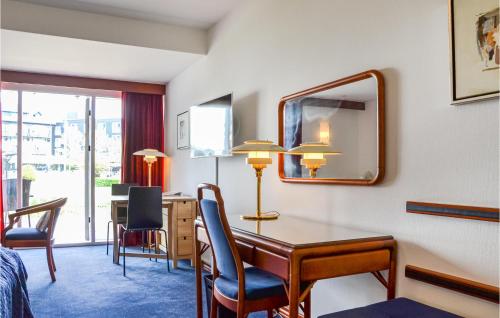 a hotel room with a desk and a mirror at Studio Apartment In Helsingor in Helsingør