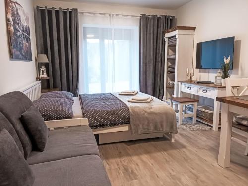 una sala de estar con una cama y un sofá en Studio Vista 1 by Interhome, en Rokytnice nad Jizerou