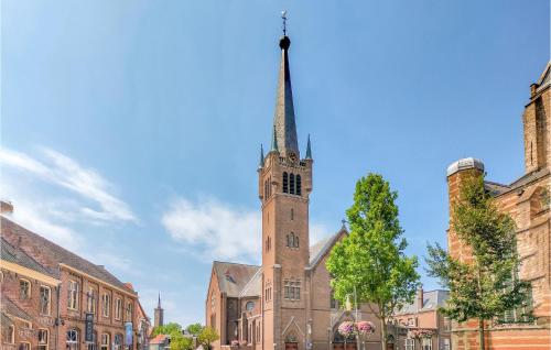 a church with a tall steeple on top of it at Awesome Home In Heinkenszand With Wifi in Heinkensand