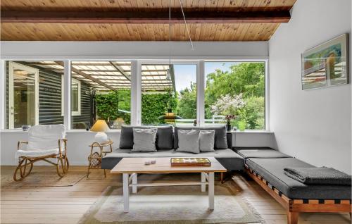 a living room with a couch and a table at Holiday Home Vejby With Fireplace I in Vejby