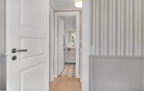 a hallway with a white door and a bathroom at Lovely Home In Føllenslev With Wifi in Føllenslev