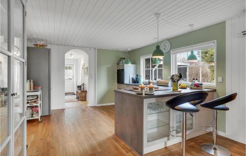 a kitchen with a counter and two stools at Beautiful Home In Højby With Wifi in Højby