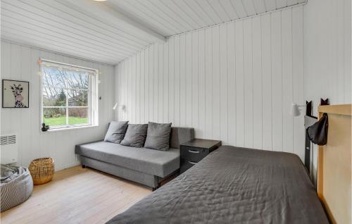 a bedroom with a bed and a couch and a window at Beautiful Home In Højby With Wifi in Højby