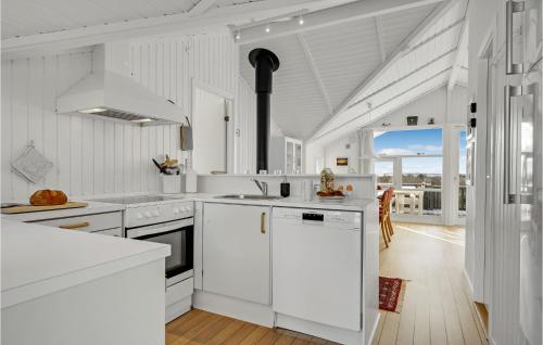 a white kitchen with white counters and appliances at Stunning Home In Sjællands Odde in Yderby