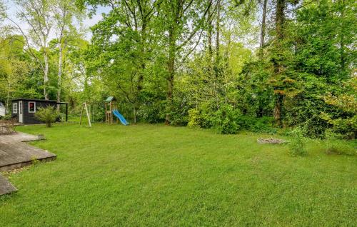 a yard with a playground and a swing at 3 Bedroom Amazing Home In Glesborg in Glesborg
