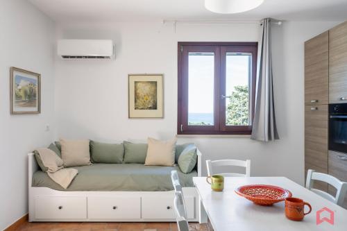 a living room with a couch and a table at Cute Holiday Home & Pool by Scopello Sea in Scopello