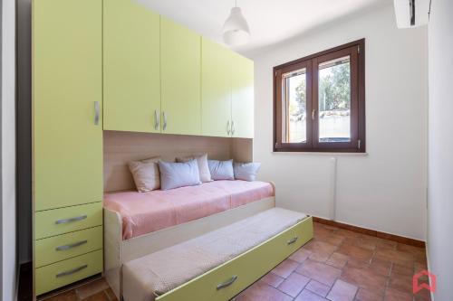 a bedroom with a bed and a window at Cute Holiday Home & Pool by Scopello Sea in Scopello