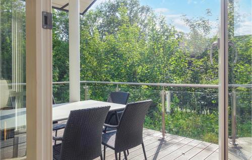 a patio with a table and chairs on a balcony at Stunning Home In Rønne With Wifi in Rønne