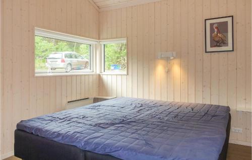 a bedroom with a bed and a window at Stunning Home In Rønne With Wifi in Rønne