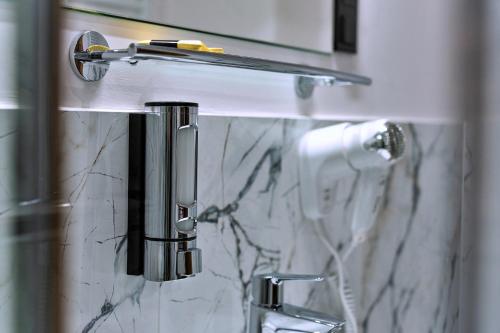 a bathroom with a marble sink and a shower at Elegant Apartments in Poznań