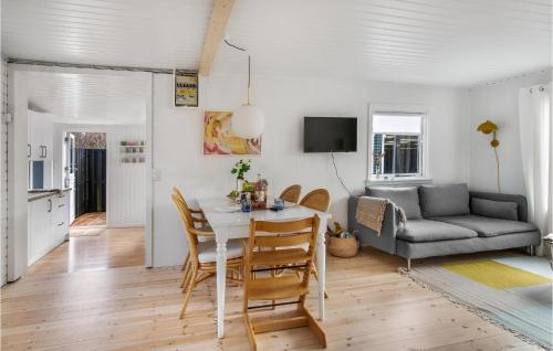 a dining room and living room with a table and chairs at Stunning Home In Nykøbing Sj With Wifi in Nykøbing Sjælland