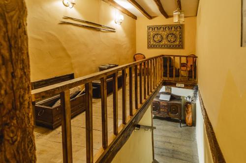 a room with a staircase with a wooden railing at Laguna Herrera in Campo de Cuéllar
