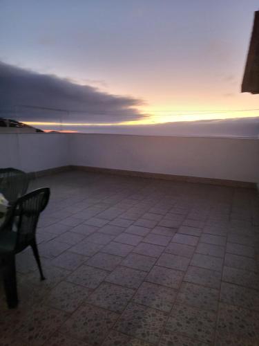 a empty room with a chair and a sunset at Casa Sara 2 in Icod de los Vinos