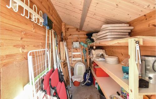 a room in a wooden cabin with skis on a shelf at Two-Bedroom Holiday Home In Nyborg in Nyborg
