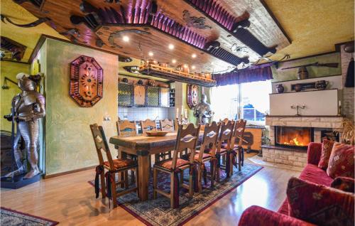 una sala da pranzo con tavolo, sedie e camino di Gorgeous Home In Nordwestuckermark a Holzendorf