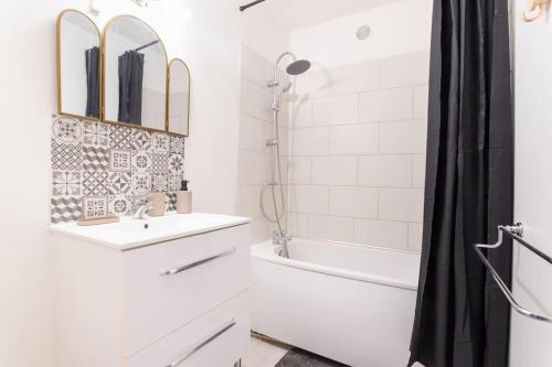 une salle de bain blanche avec un lavabo et une douche dans l'établissement Sublime Appartement proche de la Gare - Babyfoot, à Douai