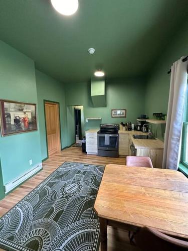 a living room with a table and a kitchen at Upper Yellowstone Suite in Livingston