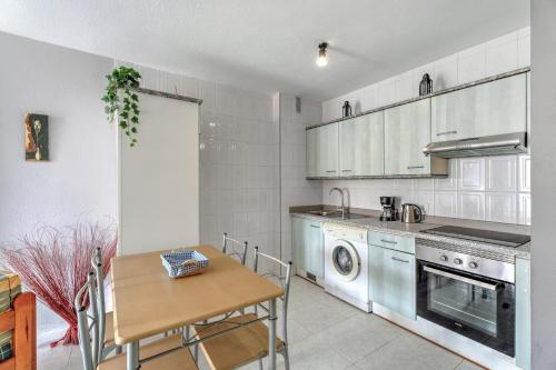 a kitchen with a table and a dining room at Apartamento Retama in Adeje