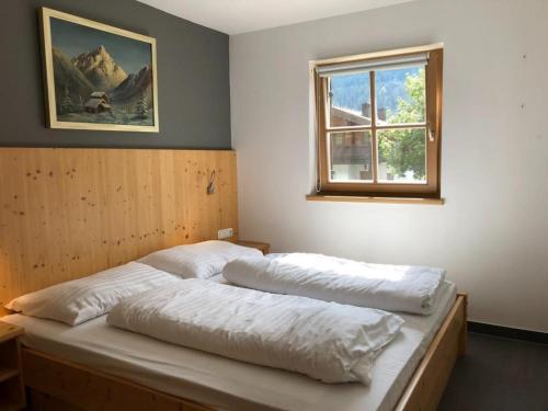 une chambre avec deux lits et une fenêtre dans l'établissement Schöneben Traumhütte, à Wald im Pinzgau