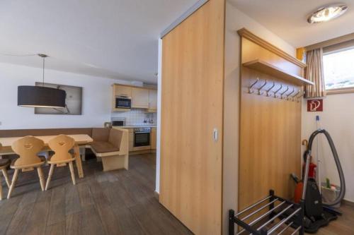 a kitchen and dining room with a table and chairs at Schöneben Haus Anemone in Wald im Pinzgau